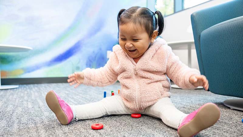 A girl plays in the waiting area at Seattle Children's Magnuson Clinic