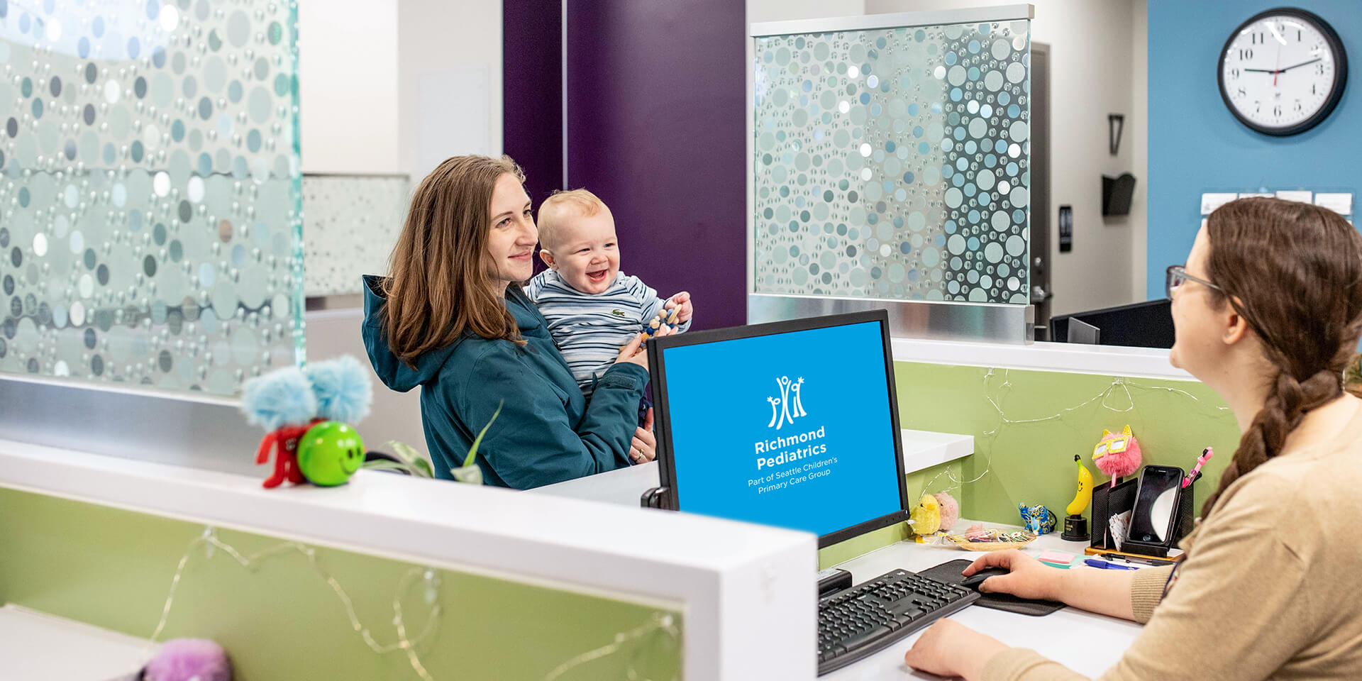 Baby with parent at reception desk